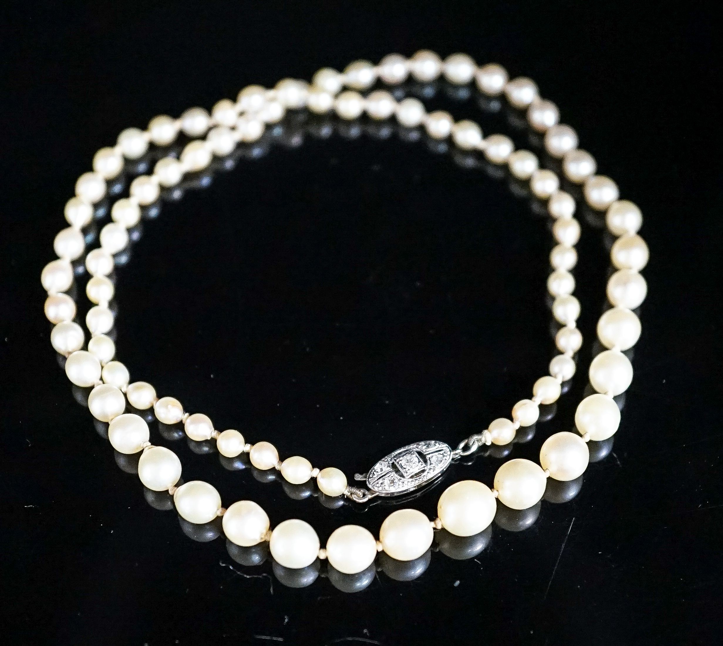 A single strand graduated cultured pearl necklace, with diamond set 14ct and plat clasp, 47cm, gross 13.3 grams.
